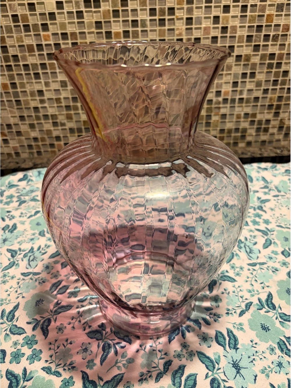 This is a vintage mid-20th century pink textured glass vase.
